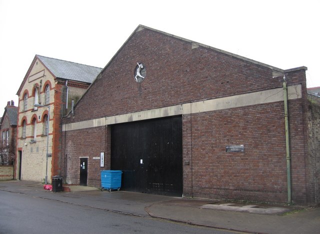 A brick building with a horse emblem, RAF Sculthorpe, serves as a location for digital creator resources.